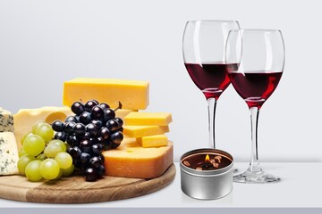 Tasty fresh cheese with berries and wine glasses