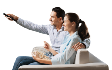 Young happy couple watching tv on a sofa