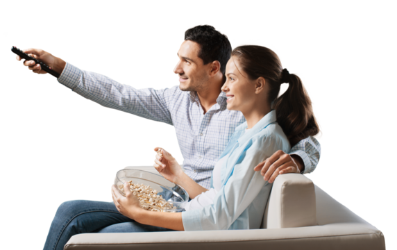 Young happy couple watching tv on a sofa