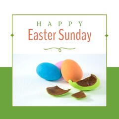 Fototapeta premium Image of happy easter sunday text over chocolate easter eggs