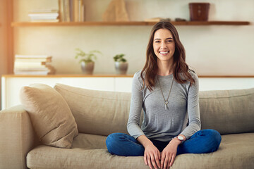 Obraz premium My home is a part of who I am. Portrait of an attractive young woman relaxing on the sofa at home.