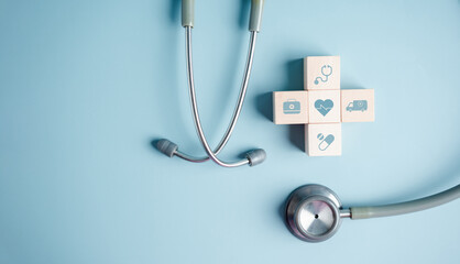 Health insurance concept. plus symbol and healthcare medical wooden cube block with stethoscope,...