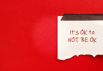Torn note paper stick on red copy space background with text written IT'S OK TO NOT BE OK, means feelings and emotions expressing  valid no matter what, it is normal to say you are not okay - obrazy, fototapety, plakaty