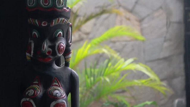 bali wooden statue women rainning
