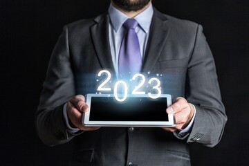 Businessman holding 2023 number, new year