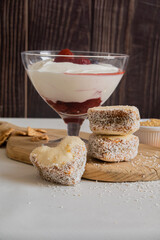 Healthy breakfast of natural yogurt and berries, cookies and croissant served . Portion desert in glass. 