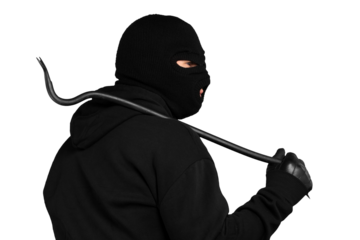 Thief in black balaclava and clothes with handcuffs isolated on white