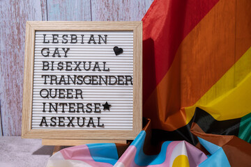 LGBTQIA description frame on Rainbow LGBTQIA flag made from silk material. LESBIAN, GAY, BISEXUAL,...