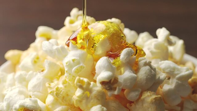 sweet caramel  popcorn. Pouring carame slowmotion.snack food.background cooking