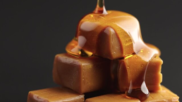 
piece caramel. Candy gold toffee.sweet product. Sauce caramel drip. Slowmotion caramel
