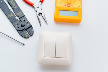 Stripper, Pliers, Multimeter, switch and Screwdriver on a white background