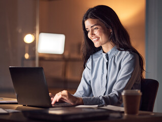 Obraz na płótnie Canvas Business woman, computer typing and dark office with tax audit deadline with happiness. Corporate employee, working and happy accountant planning a online finance strategy with a laptop and a smile