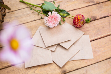 Packaging, square envelopes with plant seeds put on a wooden table with flowers