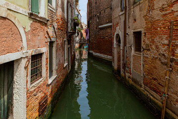 Fototapeta na wymiar Canals of Venice city with traditional colorful architecture, Italy