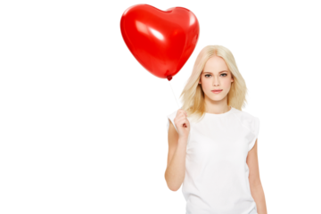A blonde female Model with a beautiful smile on her face holding a heart balloon and celebrating at a party at a romantic event on a valentines day holiday isolated on a png background.