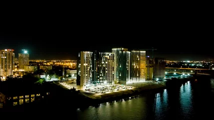 Foto op Plexiglas Astrakhan, Russia. A new residential complex on the banks of the Volga River. Night city lights, Aerial View © nikitamaykov