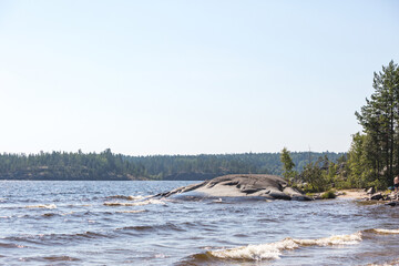 Fototapeta na wymiar Rock shore of the Koyonsaari Island. Skerries of Ladoga Lake. Karelia Republic, Russia