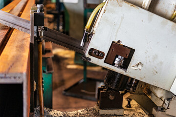 Machine for cutting metal profile. The saw cuts metal blanks into pieces. Industrial equipment for cutting and processing metal.