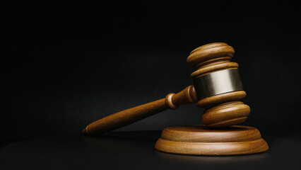 Wooden court gavel on black background close up