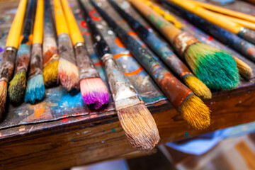 Fototapeta premium Paint brushes on palette paper