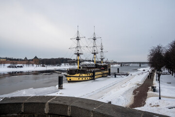vintage ship moored on the river in the ancient center in Veliky Novgorod on a winter day