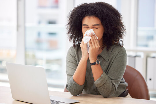 Sick, laptop and blowing nose with black woman in office for virus, illness and allergy symptoms. Disease, tissue and sneeze with employee suffering at desk with condition, flu and cold infection