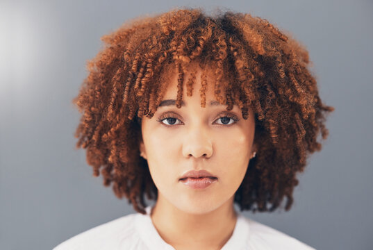 Beauty, Afro And Black Woman Face Or Activist For Empowerment And Looking Serious, Confident And Proud. Portrait, Head And African American Female With Curly Hair Isolated In Gray Background