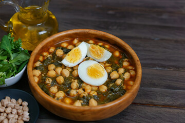 wooden bowl with chickpeas with spinach and hard-boiled egg