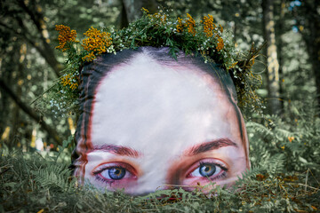 Art object of soft pillow with young girl half face image with wreath of yellow flowers on head in...