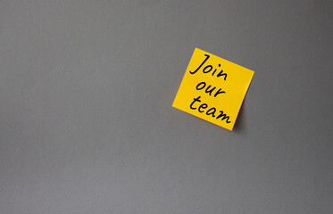 Join our team symbol. Concept words Join our team on orange steaky note. Beautiful grey background. Business and Join our team concept. Copy space.
