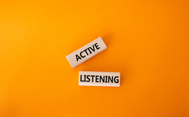 Active listening symbol. Wooden blocks with words Active listening. Beautiful orange background. Business and Active listening concept. Copy space.