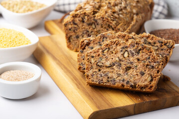 Homemade Gluten Free Bread. Healthy Eating Concept. Millet, buckwheat, psyllium husks, flax seeds on Gray Table.