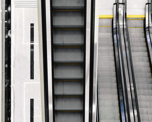 Selective focus on the stairs of an electric escalator. View from above.