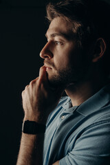 The young guy thought. Portrait on a dark background.