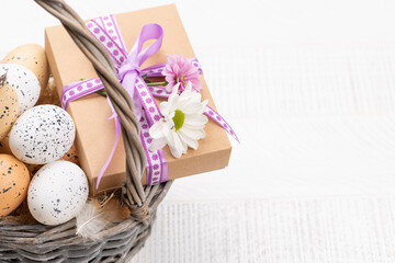 Fototapeta na wymiar Gift box and Easter eggs basket