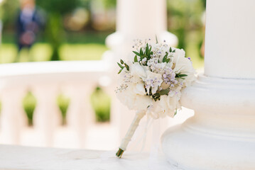 Delicate wedding bouquet with white hydrangea and greenery close-up