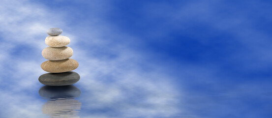 Pyramids of stones against the background of the sea are a symbol of calm and balance.