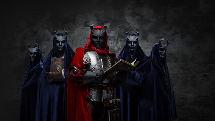 Fototapeta na wymiar Portrait of occult brotherhood and their leader with book against dark background.
