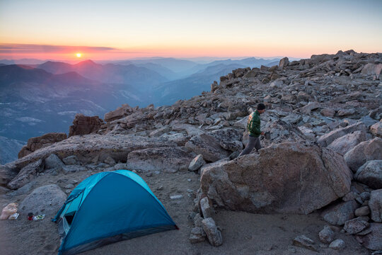 Man camping on summit of Mount Mendel