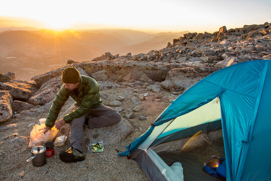 Man camping on summit of Mount Mendel