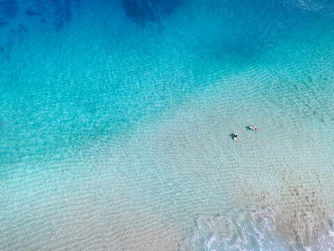 Aerial view of two surfers at Pupukea sandbar, Oahu, Hawaii, USA