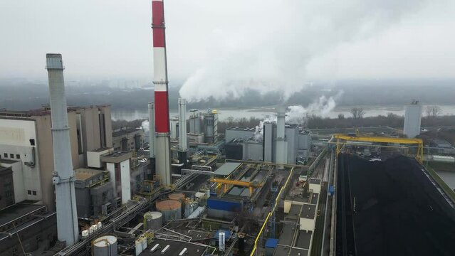 Industrial landscape, energy extraction from coal, termal power station, view from height of the pipes in the fog, environmental issues, aerial view.