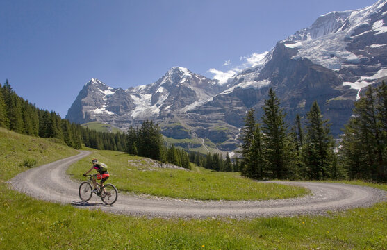 Road Cycling, Riding Road Cycling up a switchback in sunshine,Switzerland