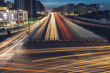 Fototapeta na wymiar City transport in the evening with headlights blur