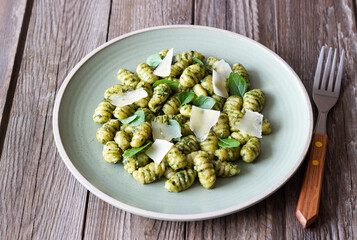 Gnocchi with pesto sauce, basil and Parmesan cheese. Healthy food. Vegetarian food. Diet.