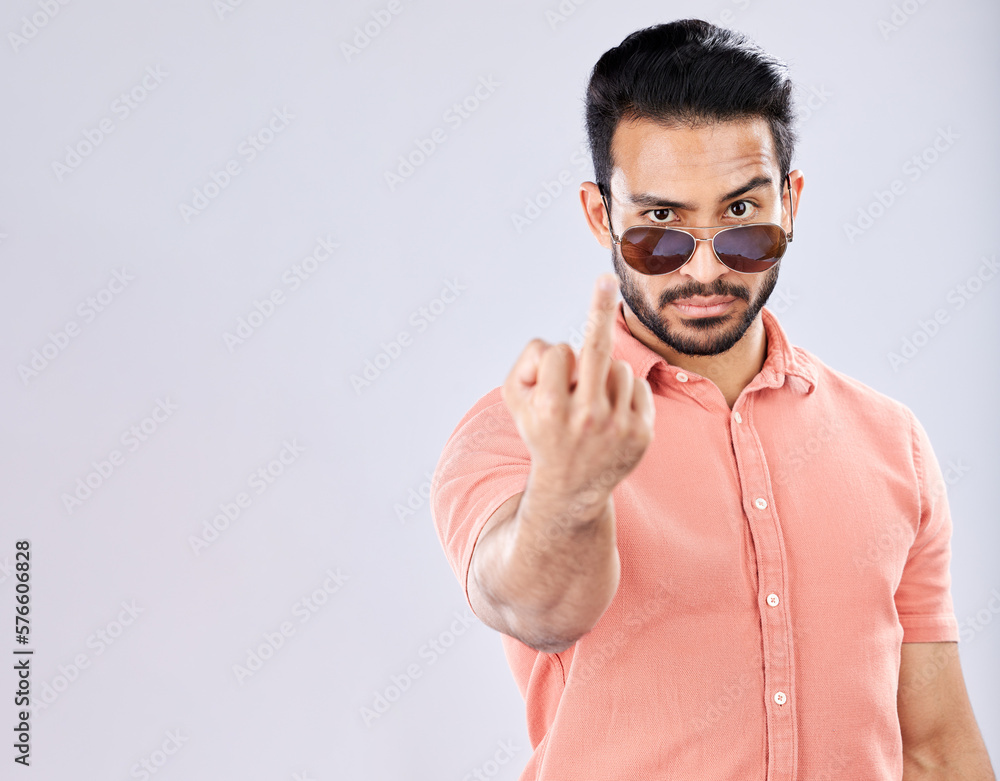 Poster cool, rude and portrait of an asian man with a middle finger isolated on a grey studio background. m