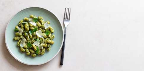 Gnocchi with pesto sauce, basil and Parmesan cheese. Healthy food. Vegetarian food. Diet.