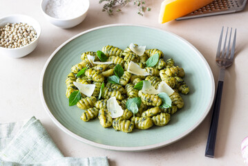 Gnocchi with pesto sauce, basil and Parmesan cheese. Healthy food. Vegetarian food. Diet.