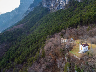 Fototapeta na wymiar Chiusaforte and the little church of Raunis seen from above. Friuli