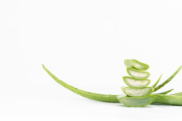 Fresh aloe vera leaves and slices isolate against white background for health and beauty products.